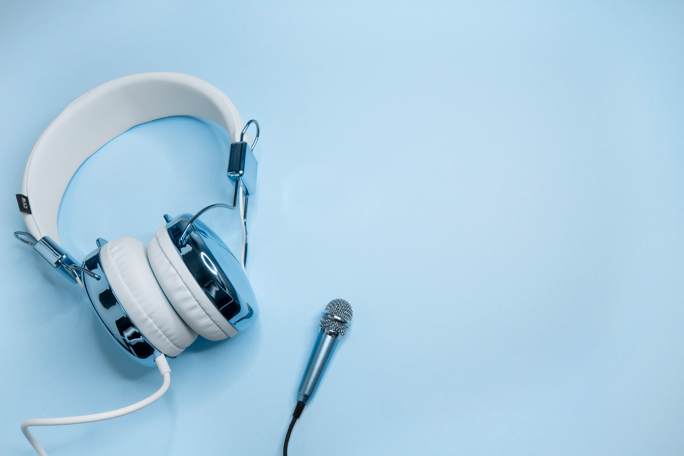 Music Background with Blue Headphones and Microphone.